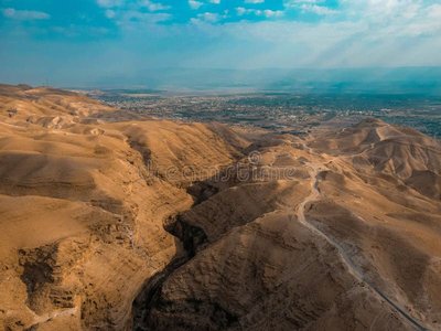stunning-aerial-view-judean-desert-rugged-hills-winding-roads-leading-to-ancient-city-jericho-israel-363589530-3032399593